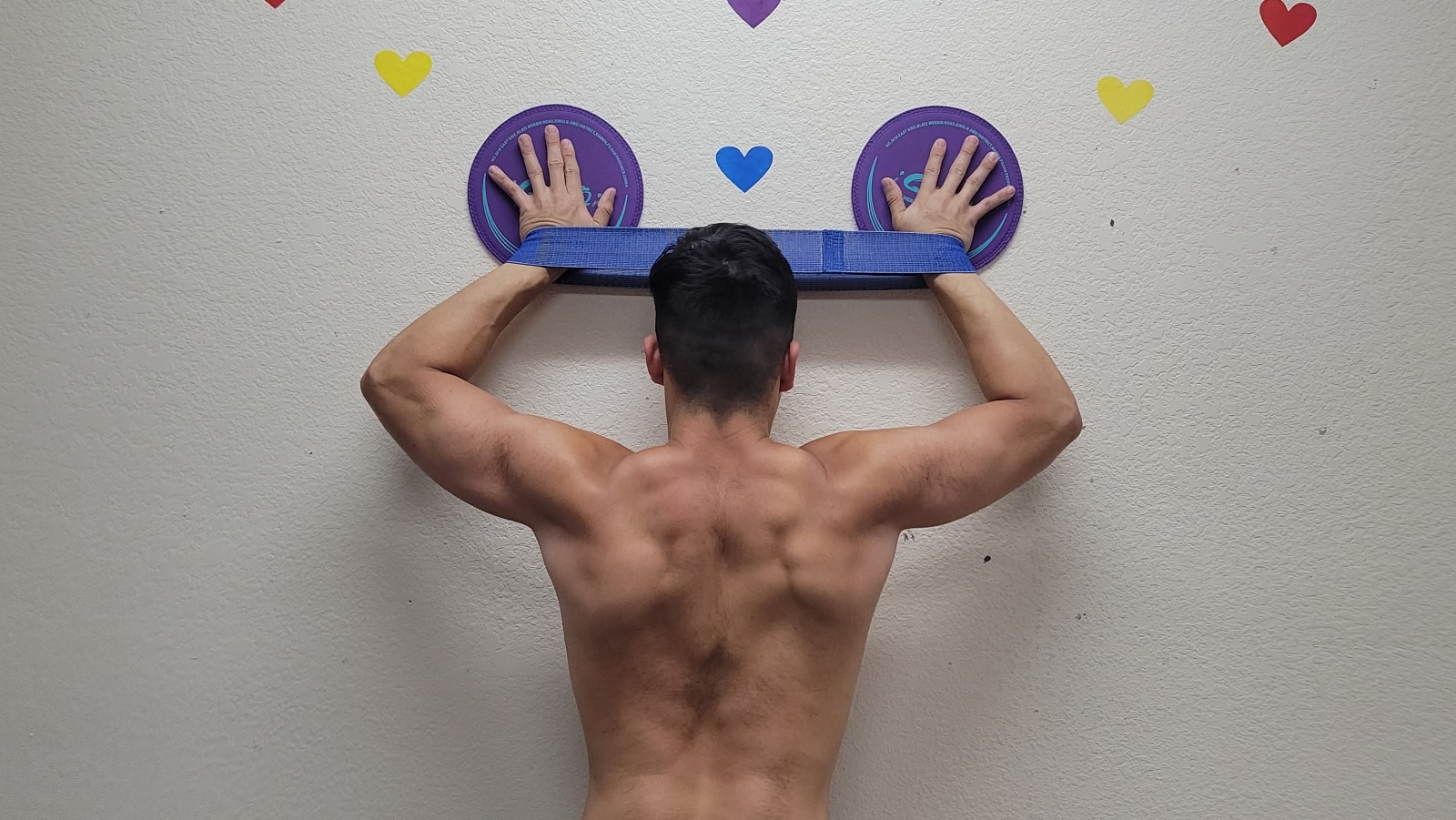 Patient performing a resistance band posture exercise to strengthen the upper back and improve shoulder alignment during physical therapy in Pembroke Pines